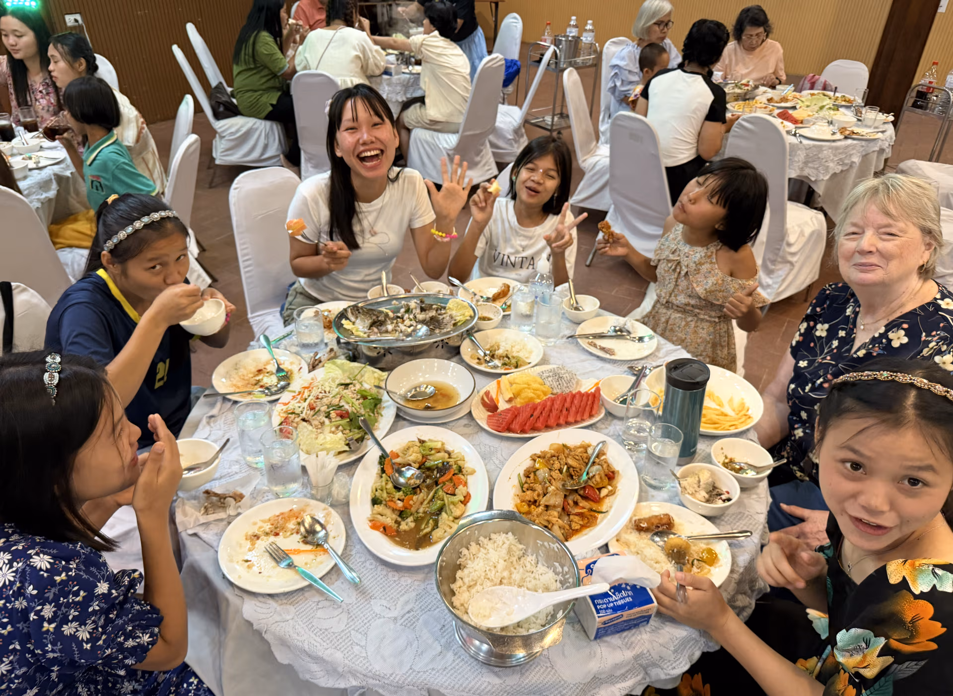Faith House girls sharing dinner with Sally